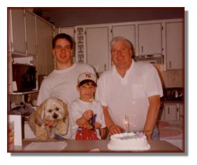 Andy celebrating a birthday with his brother Mike and father